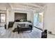 Bedroom featuring a large bed, slider to back yard, and grey wood-look flooring at 1805 Ivanhoe Way, Las Vegas, NV 89102