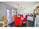 Dining room featuring striking red chairs and modern lighting fixtures at 1805 Ivanhoe Way, Las Vegas, NV 89102