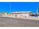 Single-story home with front yard featuring xeriscaping, a double-door garage, and large driveway at 1805 Ivanhoe Way, Las Vegas, NV 89102