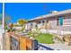 Single-story home featuring desert landscaping, rock accents, and a wooden gate at 1805 Ivanhoe Way, Las Vegas, NV 89102