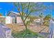 Single-story home with a gated front yard, mature trees, and desert landscaping at 1805 Ivanhoe Way, Las Vegas, NV 89102