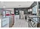 Open-concept kitchen with stainless steel appliances and eye-catching geometrically patterned accent wall at 1805 Ivanhoe Way, Las Vegas, NV 89102