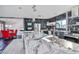 This kitchen includes a stainless steel range, custom cabinetry, and countertops with black backsplash at 1805 Ivanhoe Way, Las Vegas, NV 89102