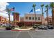 Exterior view of a well-maintained complex with palm trees, landscaping, and ample parking at 19 E Agate Ave # 307, Las Vegas, NV 89123