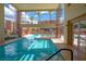 Indoor community pool with lounge chairs overlooking exterior pool at 19 E Agate Ave # 307, Las Vegas, NV 89123