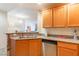 Well-lit kitchen featuring granite countertops, stainless steel dishwasher, and light wood cabinets at 19 E Agate Ave # 307, Las Vegas, NV 89123