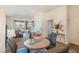 Bright living room with dining area featuring plush carpet, neutral walls, and lots of natural light at 19 E Agate Ave # 307, Las Vegas, NV 89123