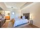 Relaxing main bedroom with a tray ceiling, plush carpet, and connecting main bathroom at 19 E Agate Ave # 307, Las Vegas, NV 89123