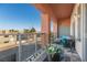 Outdoor patio with glass railing, seating, grill, and neighborhood view at 19 E Agate Ave # 307, Las Vegas, NV 89123