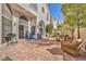 Backyard paver patio with outdoor seating, barbecue grill, and sliding glass doors to the home at 2107 Eaglepath Cir, Henderson, NV 89074