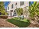 Backyard featuring outdoor seating, manicured faux grass, and landscaped rock features at 2107 Eaglepath Cir, Henderson, NV 89074