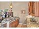 Elegant bar area with granite countertops, a sink, custom cabinets, and adjacent gaming machines at 2107 Eaglepath Cir, Henderson, NV 89074