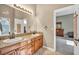 Bright bathroom boasts double sinks with granite countertops and wood cabinetry at 2107 Eaglepath Cir, Henderson, NV 89074