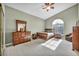 Spacious bedroom with carpet, ceiling fan, large window, and coordinated furniture set at 2107 Eaglepath Cir, Henderson, NV 89074