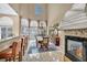 Bright dining area featuring tile floors, a stone fireplace, and a large window at 2107 Eaglepath Cir, Henderson, NV 89074