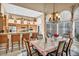 Formal dining room with chandelier, breakfast bar, and ample natural light at 2107 Eaglepath Cir, Henderson, NV 89074