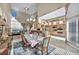 Open-concept dining area featuring a fireplace, kitchen, and access to natural light at 2107 Eaglepath Cir, Henderson, NV 89074