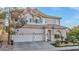 Charming two-story home featuring a three-car garage, arched windows, and a well-manicured front yard at 2107 Eaglepath Cir, Henderson, NV 89074