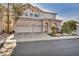 Charming two-story home featuring a three-car garage, arched windows, and a well-manicured front yard at 2107 Eaglepath Cir, Henderson, NV 89074