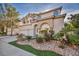 Charming two-story home featuring a three-car garage, arched windows, and a landscaped front yard at 2107 Eaglepath Cir, Henderson, NV 89074