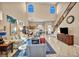 Inviting living room with a bar area, high ceilings, and staircase, perfect for entertaining at 2107 Eaglepath Cir, Henderson, NV 89074