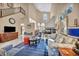 Spacious living room featuring a fireplace, high ceilings, and comfortable seating arrangement on a blue rug at 2107 Eaglepath Cir, Henderson, NV 89074