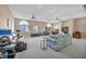 Bright living room with ceiling fans, large windows, and comfortable seating at 2107 Eaglepath Cir, Henderson, NV 89074