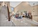 Spacious living room with high ceilings, tile flooring, and staircase leading to the second floor at 2107 Eaglepath Cir, Henderson, NV 89074