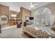 Inviting main bedroom with fireplace, ceiling fan, and French doors to a private patio at 2107 Eaglepath Cir, Henderson, NV 89074