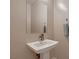 A minimalist pedestal sink with a large mirror and neutral-toned walls at 221 Errogie St, Henderson, NV 89012