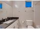 Modern bathroom with granite countertop, sleek fixtures, and bright natural light at 221 Errogie St, Henderson, NV 89012