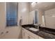 Bathroom showcasing modern fixtures, granite counters and a large window at 221 Errogie St, Henderson, NV 89012