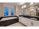 This contemporary bathroom features granite counters and a soaking tub at 221 Errogie St, Henderson, NV 89012