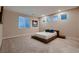 A carpeted bedroom features a ceiling fan and several sunlit windows at 221 Errogie St, Henderson, NV 89012