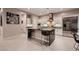 Modern kitchen featuring stainless steel appliances, a central island with seating, and white cabinetry at 221 Errogie St, Henderson, NV 89012