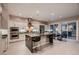 Modern kitchen with stainless steel appliances, large center island, and sliding glass doors to the outdoor space at 221 Errogie St, Henderson, NV 89012