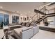 Open-concept living area showcasing a large sectional sofa and a staircase leading to upper floors at 221 Errogie St, Henderson, NV 89012