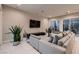 Comfortable living room featuring a plush sectional sofa, modern entertainment center, and ample natural light at 221 Errogie St, Henderson, NV 89012