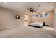 This bright, carpeted main bedroom features a ceiling fan, and a modern bed frame at 221 Errogie St, Henderson, NV 89012