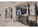 An organized walk-in closet featuring custom shelving, hanging racks and storage containers at 221 Errogie St, Henderson, NV 89012