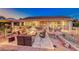 Outdoor living with an outdoor kitchen, covered patio, gas fire pit and ample seating at 2239 Discovery Lake Ct, Henderson, NV 89044