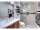 Bathroom featuring a sliding glass shower, a toilet, and a sink with modern fixtures at 2239 Discovery Lake Ct, Henderson, NV 89044