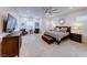 Bright bedroom featuring a ceiling fan, recessed lighting, and a sitting area with two leather chairs at 2239 Discovery Lake Ct, Henderson, NV 89044