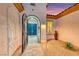 Elegant courtyard entry with iron gate and arched doorway leading to the striking blue front doors at 2239 Discovery Lake Ct, Henderson, NV 89044