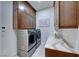 Well-organized laundry room with front-load washer and dryer, ample cabinet storage, and countertop space at 2239 Discovery Lake Ct, Henderson, NV 89044