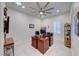 Bright office features wood desk, ceiling fan, shelving, and natural light from window and skylight at 2239 Discovery Lake Ct, Henderson, NV 89044