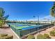 An outdoor tennis court complex featuring multiple courts with green and blue playing surfaces surrounded by fencing at 2239 Discovery Lake Ct, Henderson, NV 89044