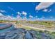 A scenic view showcasing a water feature alongside a lush green golf course against a backdrop of clear blue skies at 2239 Discovery Lake Ct, Henderson, NV 89044