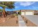 Charming single-story home featuring a three-car garage and desert landscaping at 2540 Thatcher Ave, Henderson, NV 89052