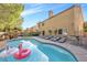 Large backyard featuring a pool, outdoor kitchen, and lounge area at 2728 Monrovia Dr, Las Vegas, NV 89117